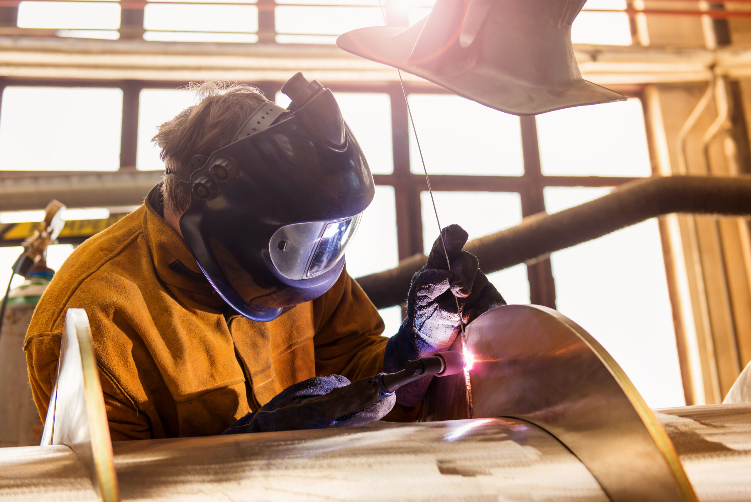 From Panic to Prepared: Building Your Emergency Action Plan 2 graphicstock young man with protective mask welding in a factory rCQmy56W scaled