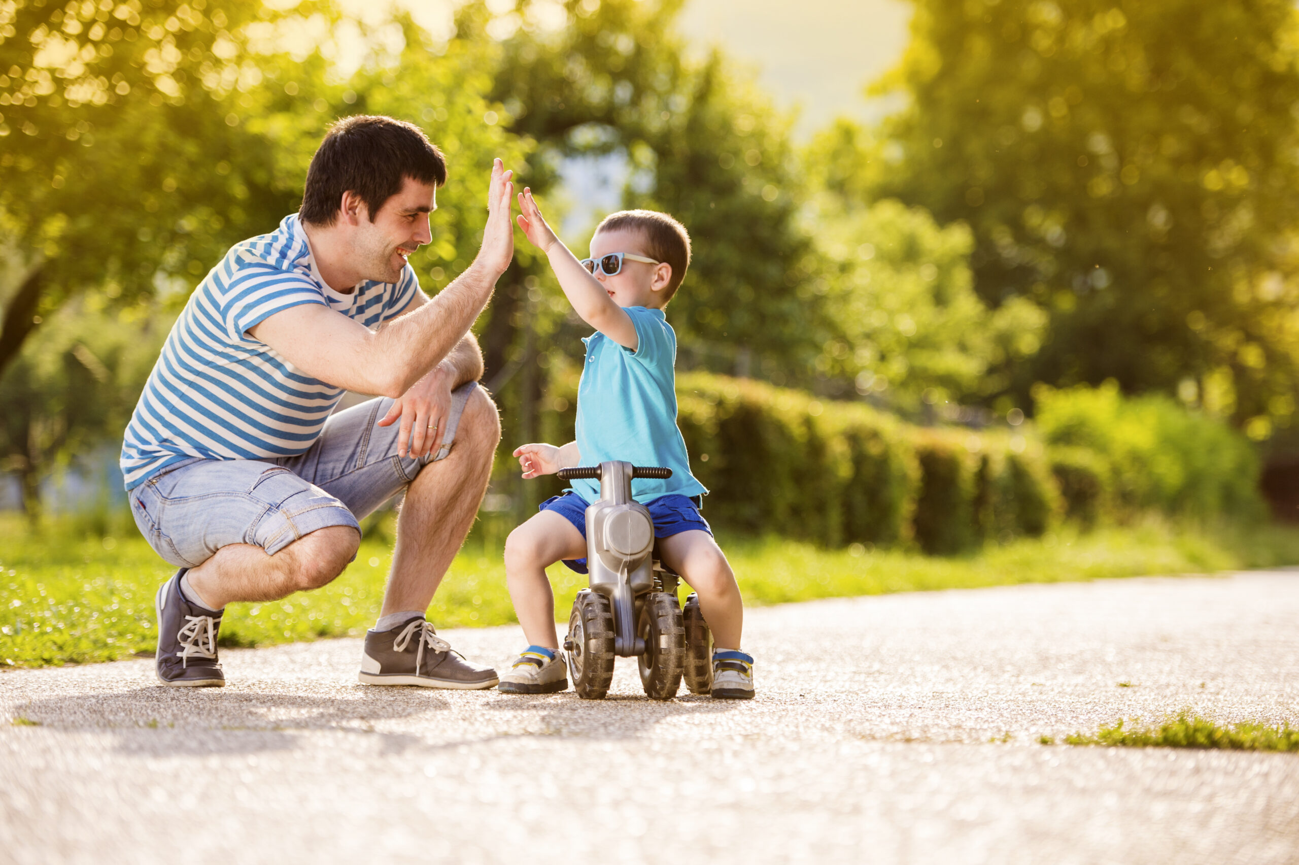 Stay Safe: Your Ultimate Guide to Disaster Preparedness 1 graphicstock young father with his little son on motorbike in green sunny park SAN9gX2bW scaled