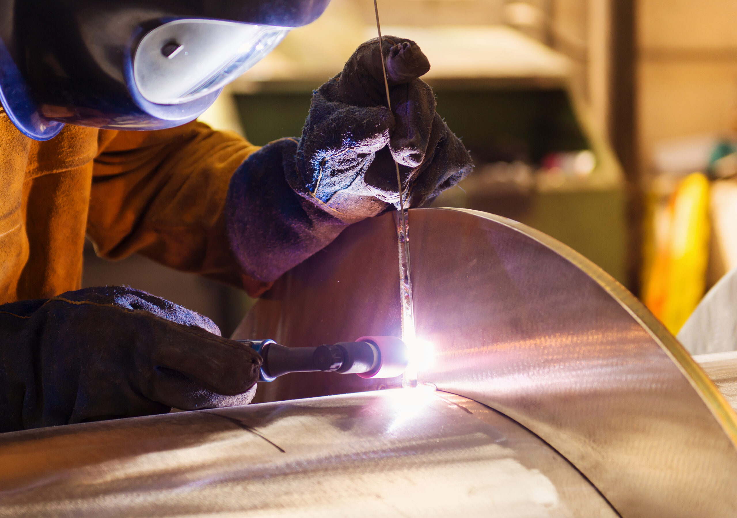 Don't Wait for the Worst: Proactive Strategies for Effective Disaster Preparedness 2 graphicstock young man with protective mask welding in a factory SCxmXkc6Z scaled